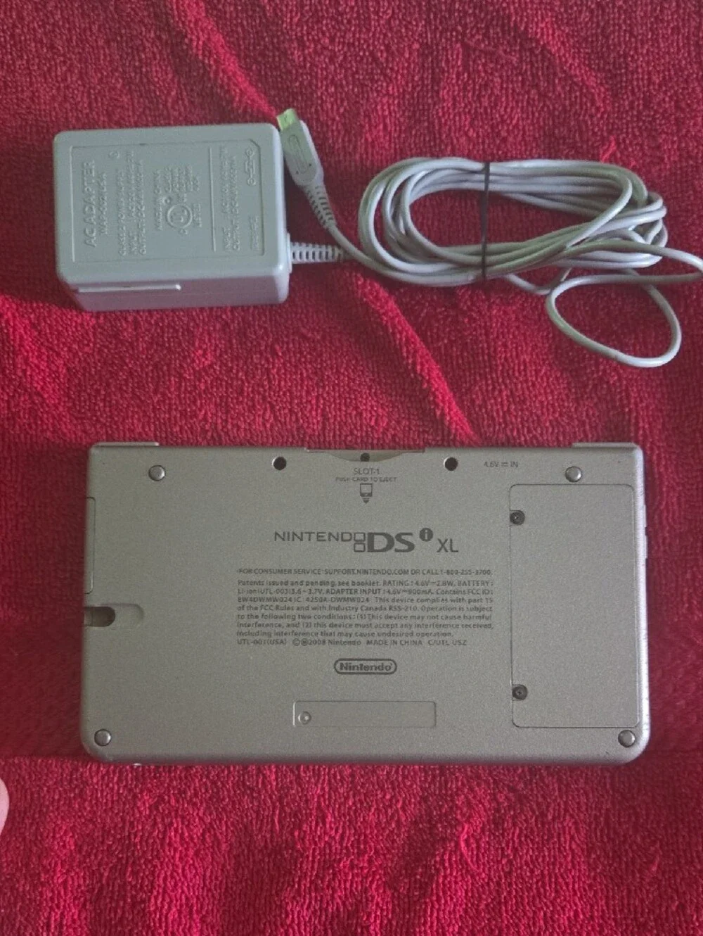 Nintendo DSi XL in black with minor scrapes and scratches